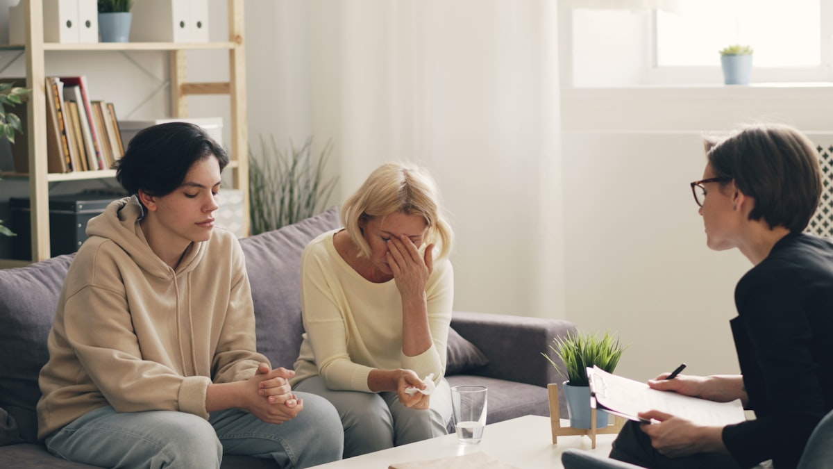 Two women in conversation on a couch